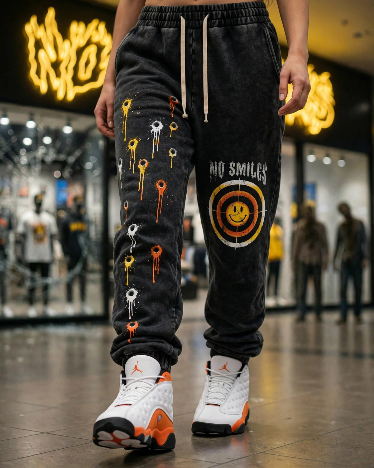 Bullseyes and Bullet Holes acid wash sweatpants worn mid-stride in front of the No Smiles store